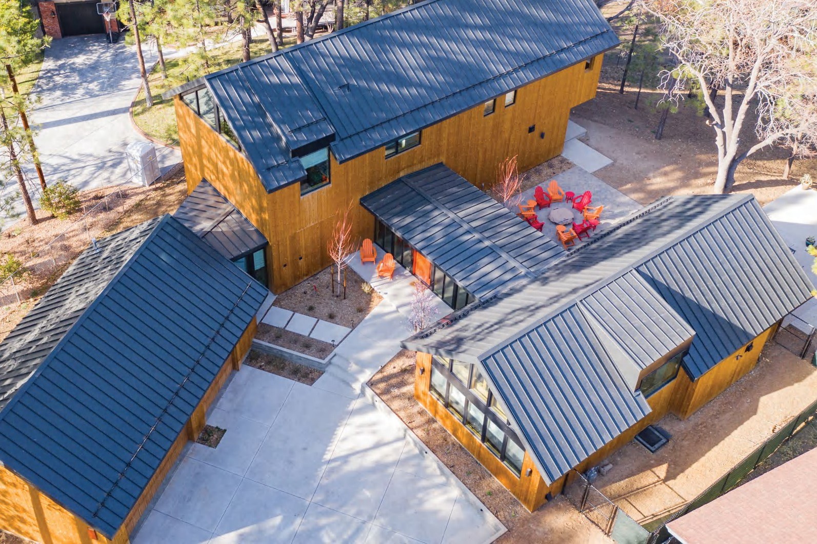 Custom Nu-Ray roof planes on a modern compound — product photography courtesy of Nu-Ray Metals