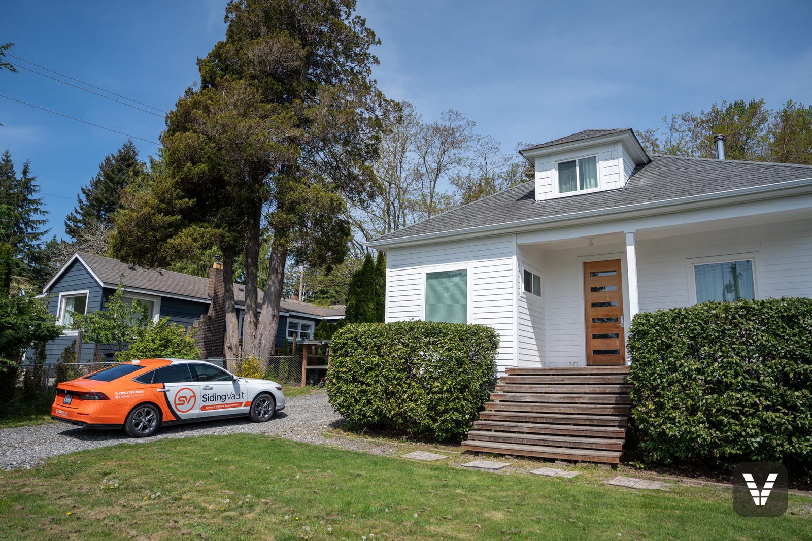 The finished bungalow from the drive, Siding Vault car out front