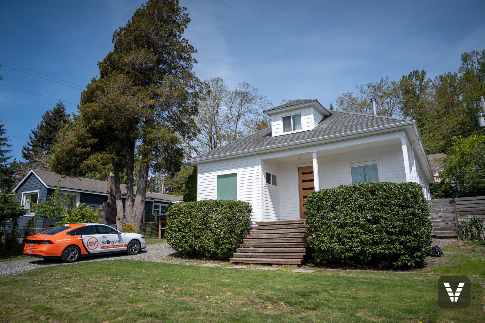 Wide view of the re-sided home in spring sun — Siding & Window Vault project in Bellingham, WA