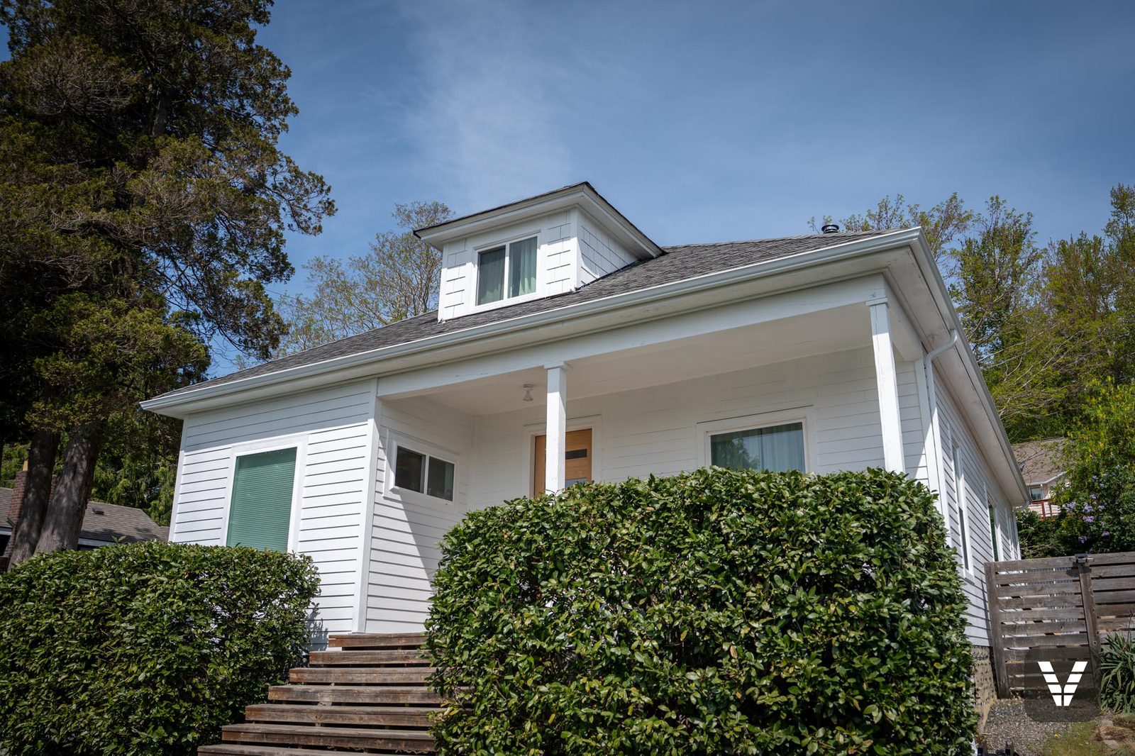Front-right corner — narrow-reveal lap and the covered porch