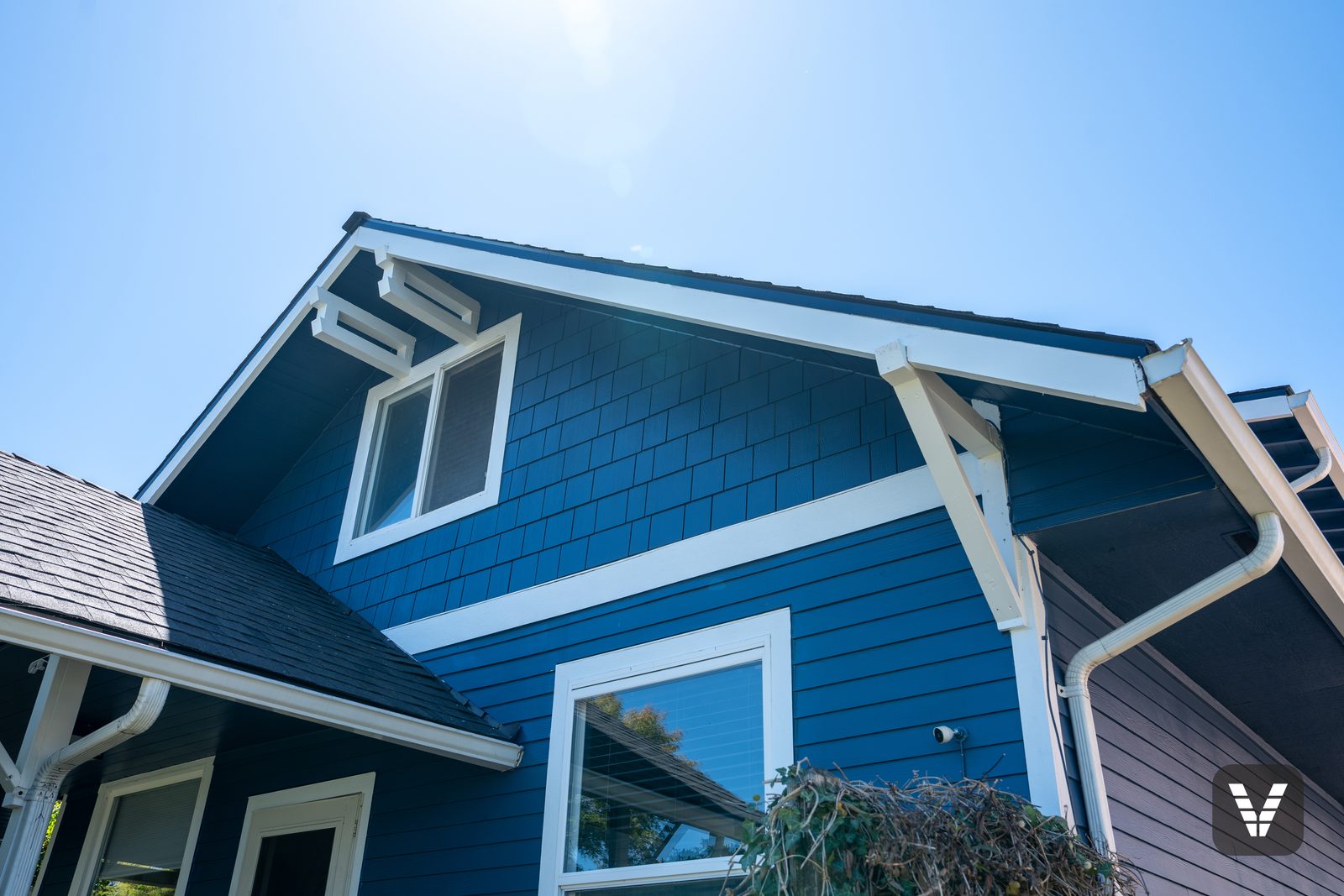 Looking up at the gable — Craftsman brackets kept, shingles renewed