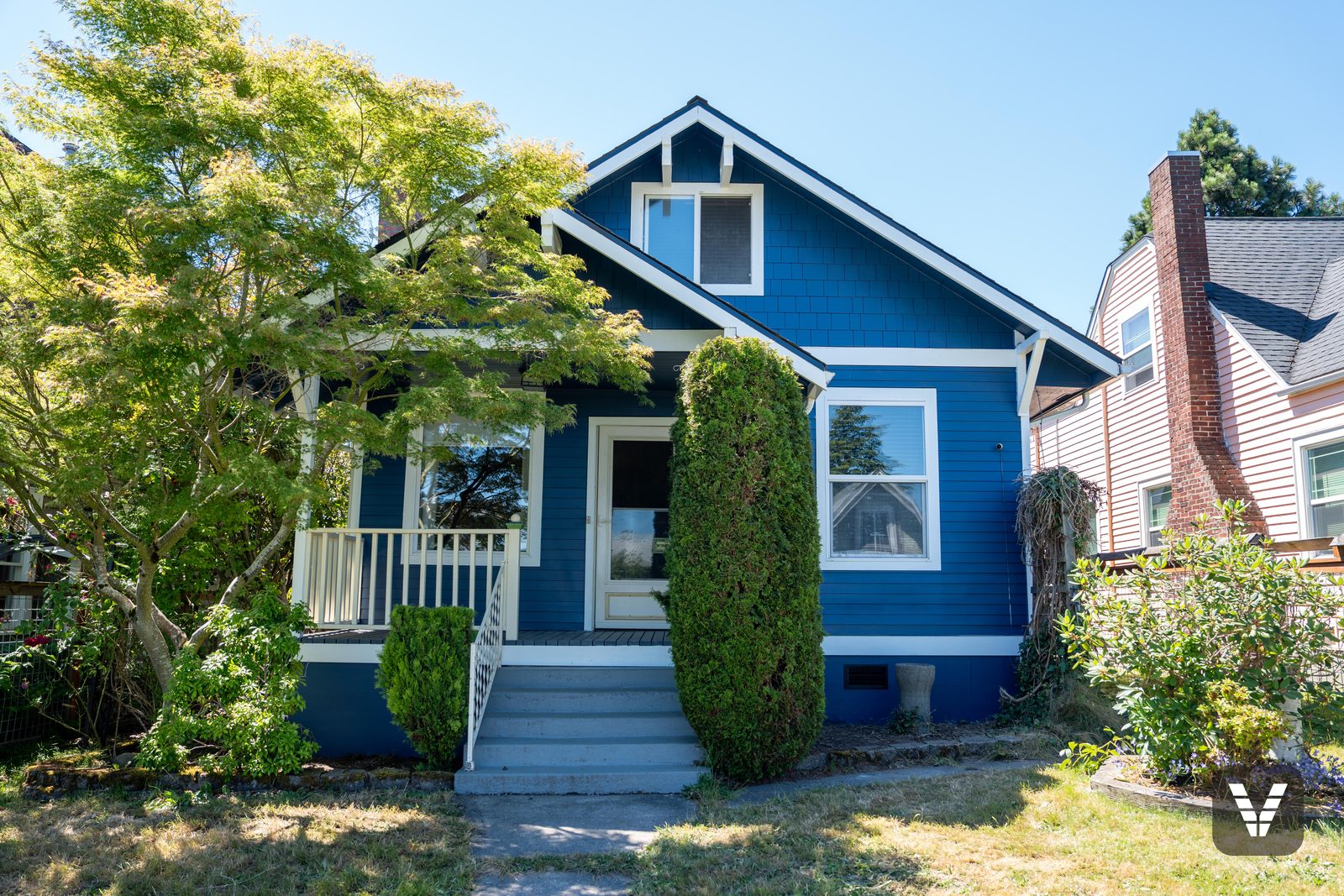 The 1918 Craftsman after its re-side — Loyal Blue HardiePlank at a 4-inch reveal, shingle gable, cream trim — after, SWV project in Bellingham, WA