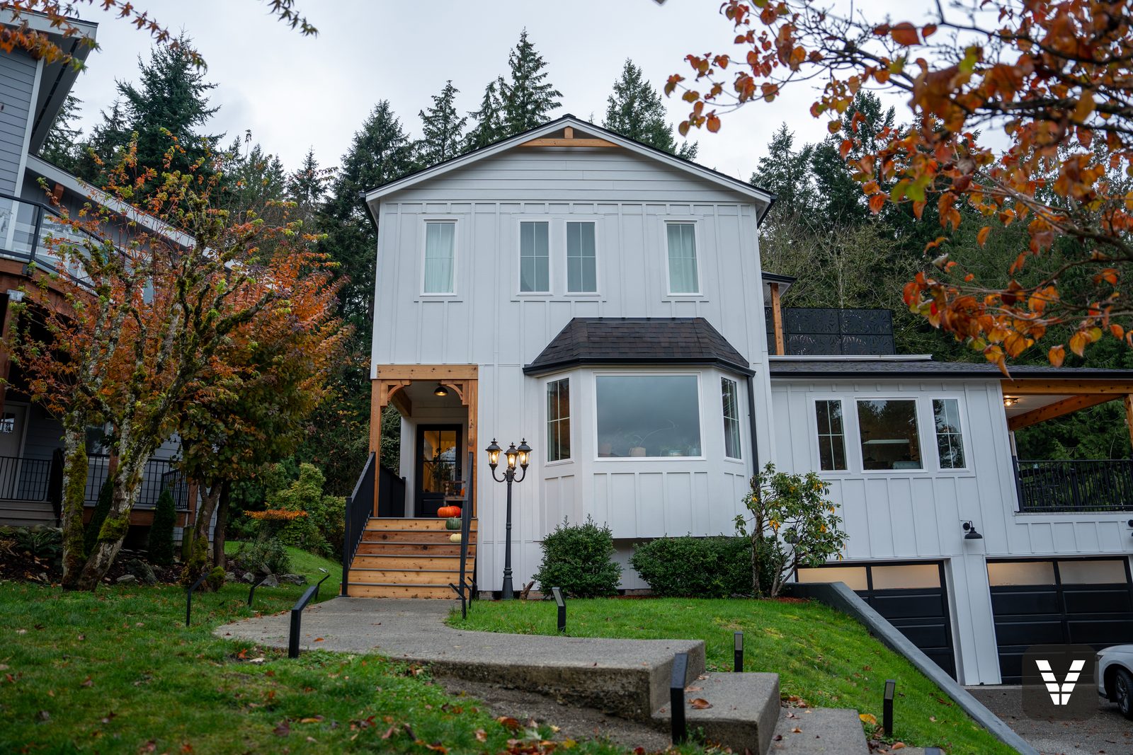 Front elevation in Arctic White board-and-batten with the new black fiberglass entry door