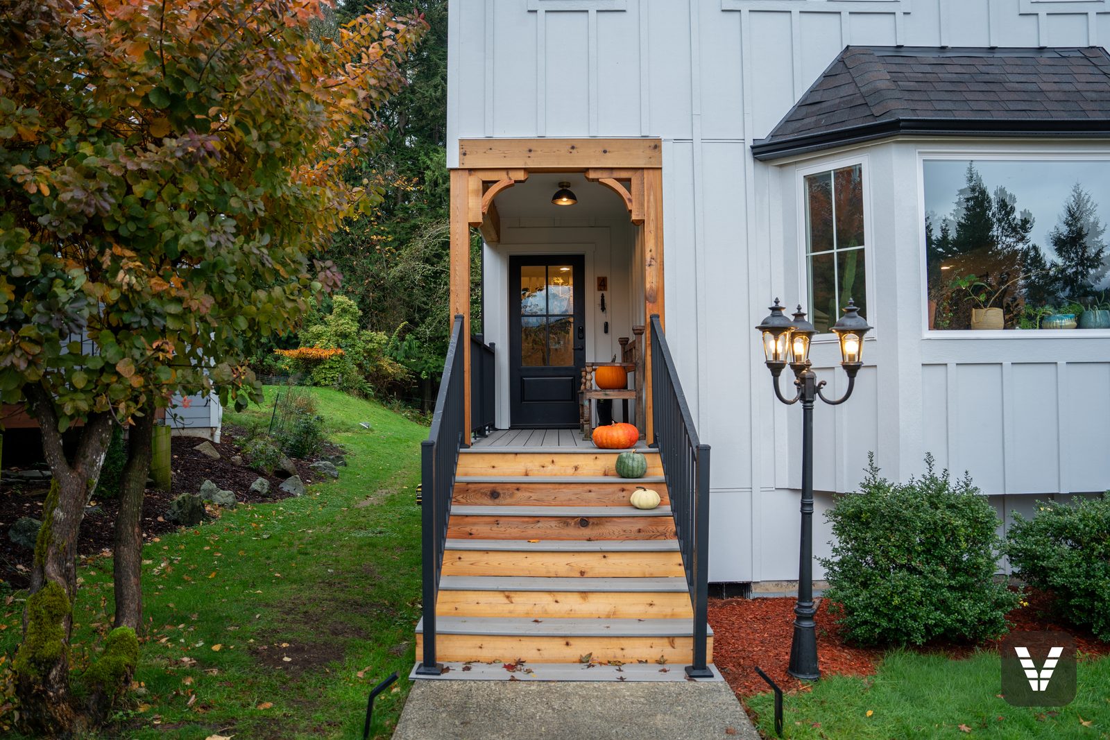 The new entry — Therma-Tru fiberglass door hung, waterproofed, and painted by Siding Vault, set in cedar and Arctic White board-and-batten — Siding & Window Vault project in Bellingham, WA