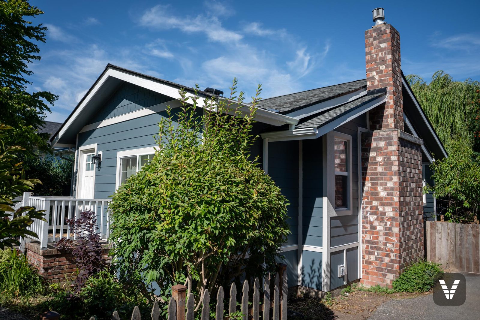 The result of a full asbestos-era siding replacement — Evening Blue Hardie lap on a Bellingham bungalow