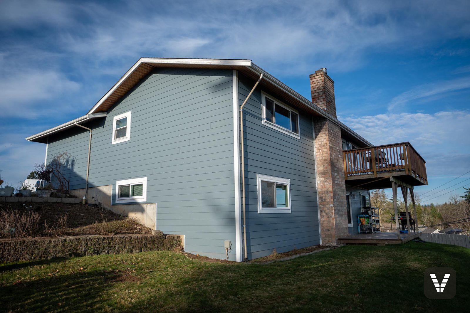 The chimney side in Boothbay Blue — the rear/side elevation from the yard — after, SWV project in Ferndale, WA