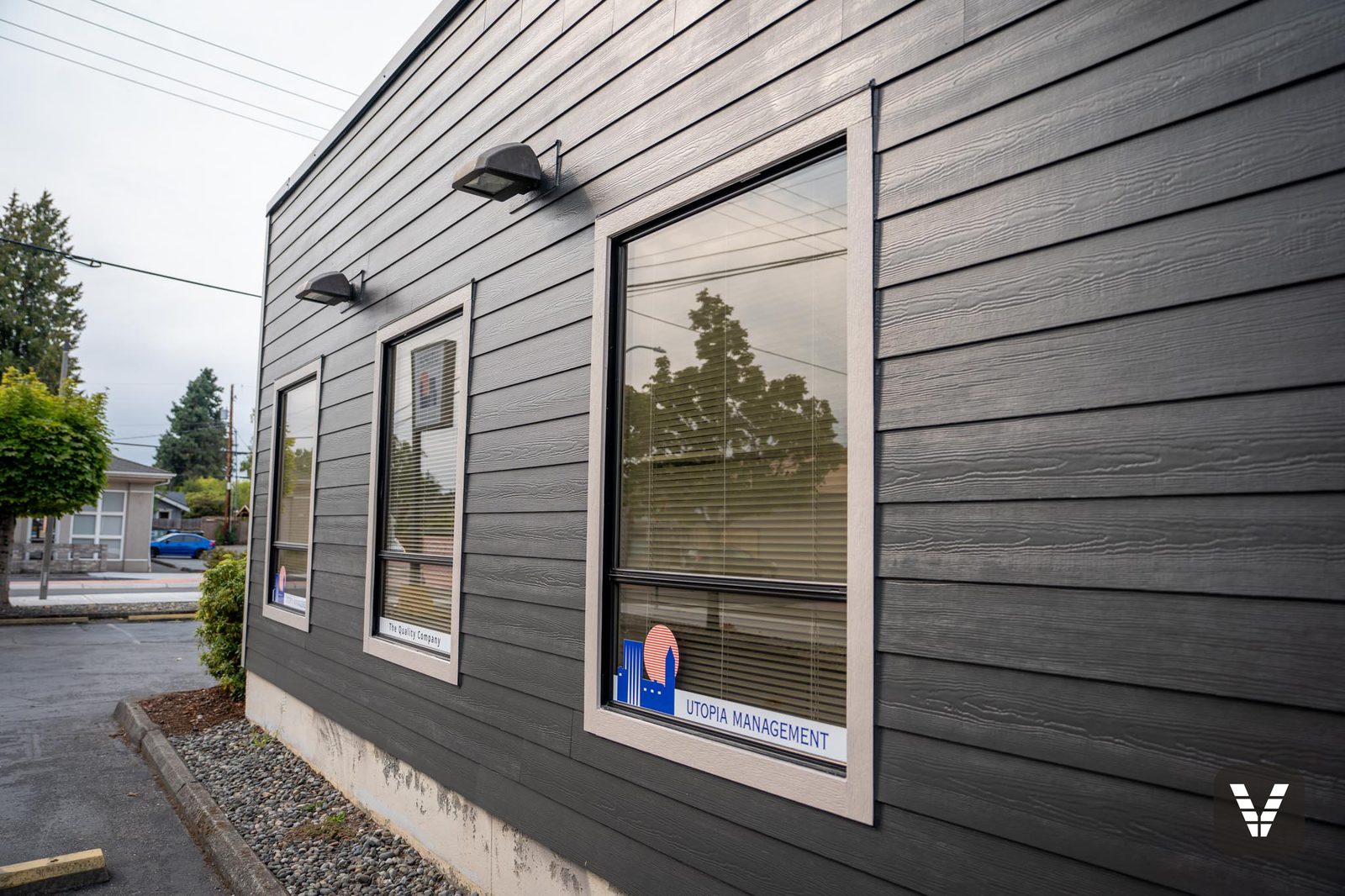 Office window wall in HardiePlank Cedarmill lap with wide HardieTrim window surrounds