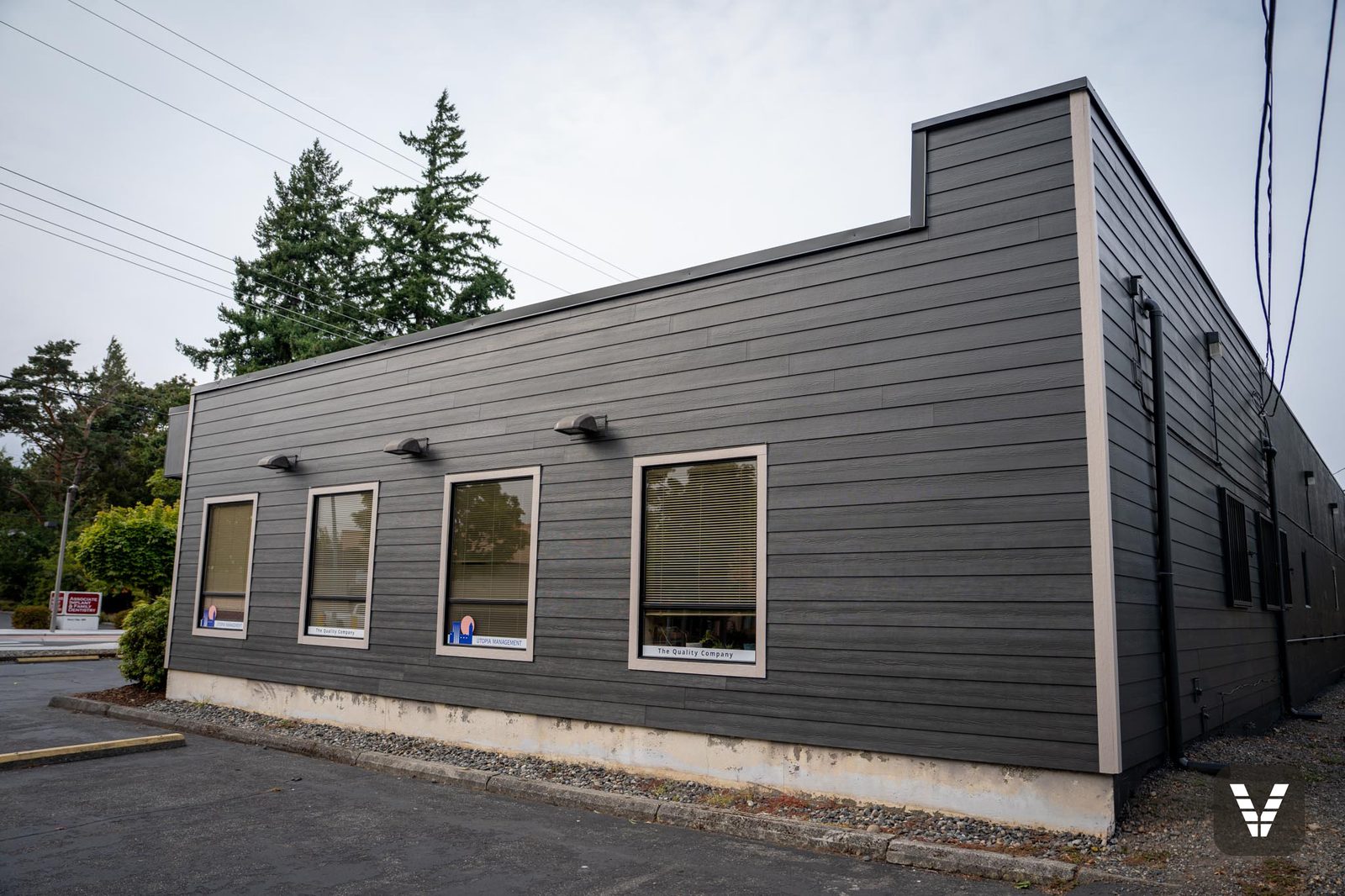Building corner showing crisp trim lines and new commercial lap siding