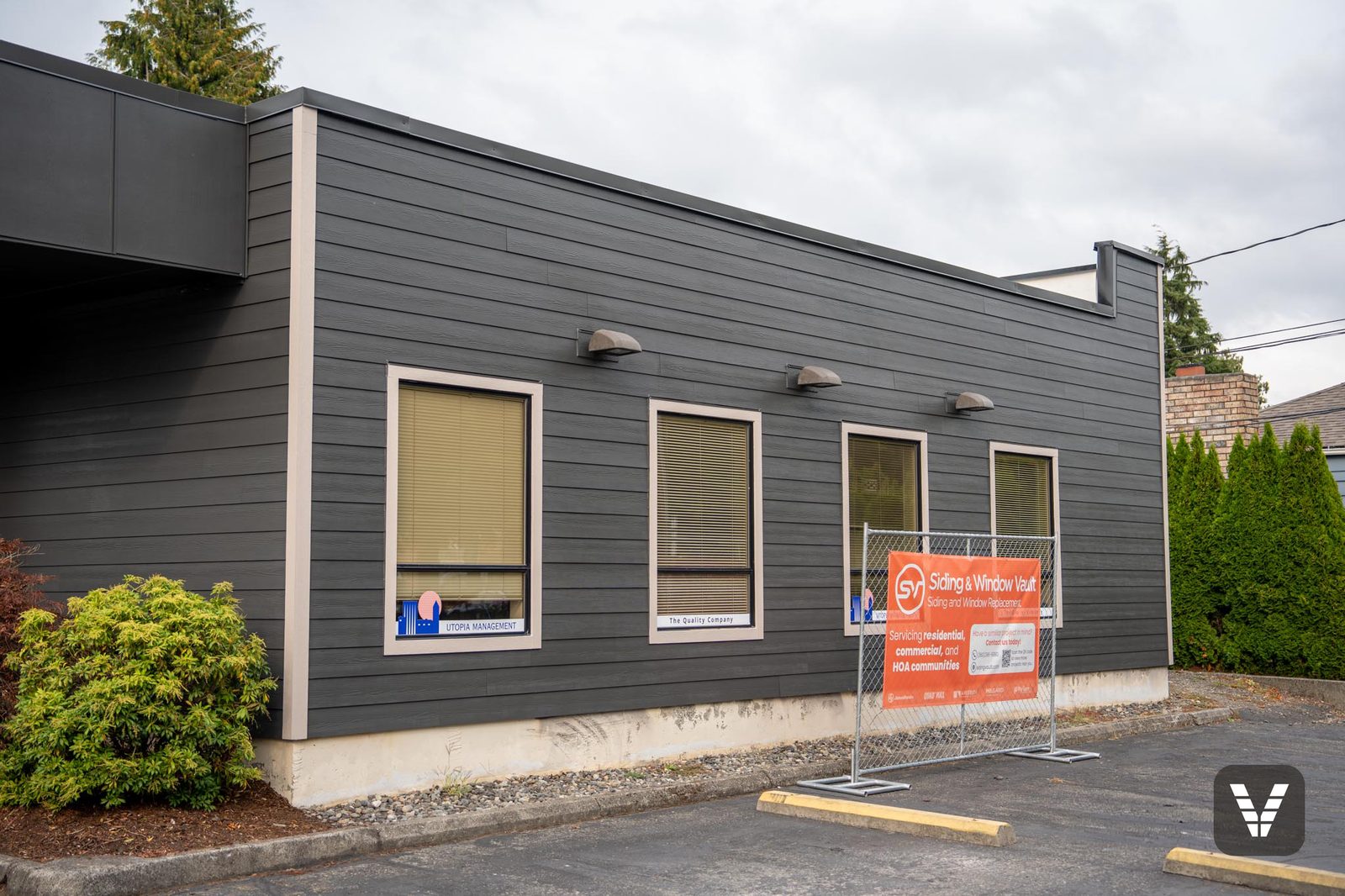 Side elevation with new siding, exterior lighting, and the Siding & Window Vault site banner