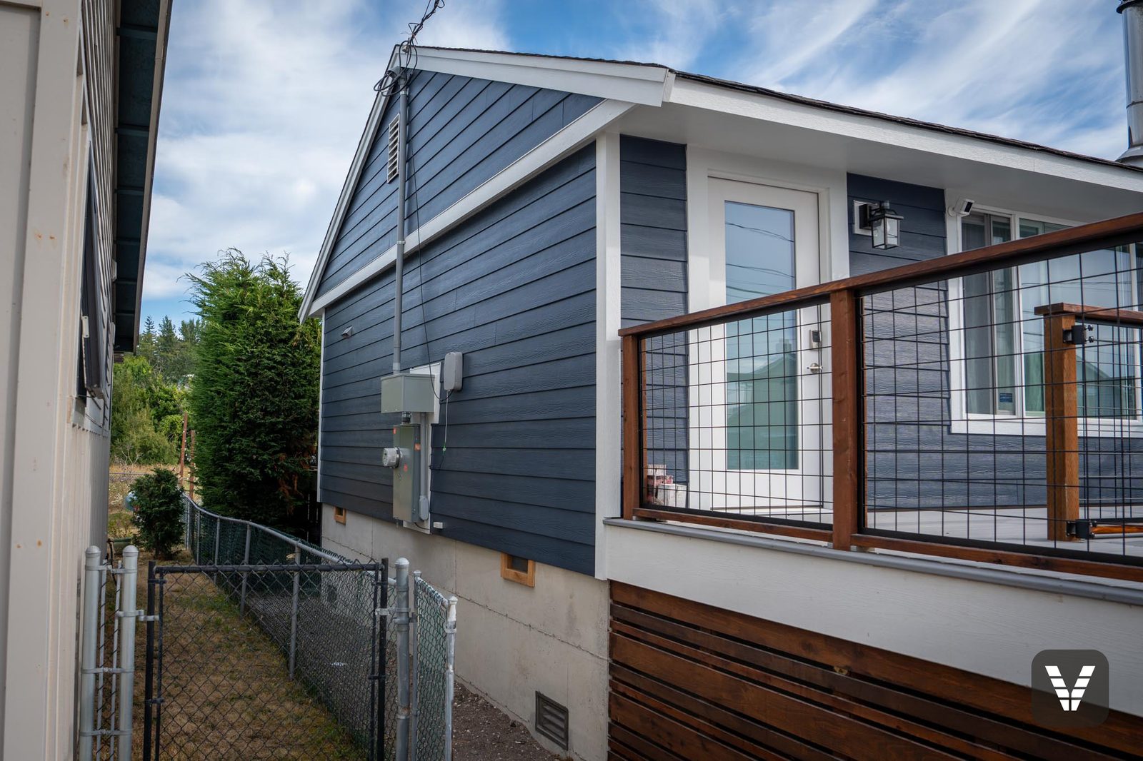 Side entry and deck rail against new Deep Ocean lap siding