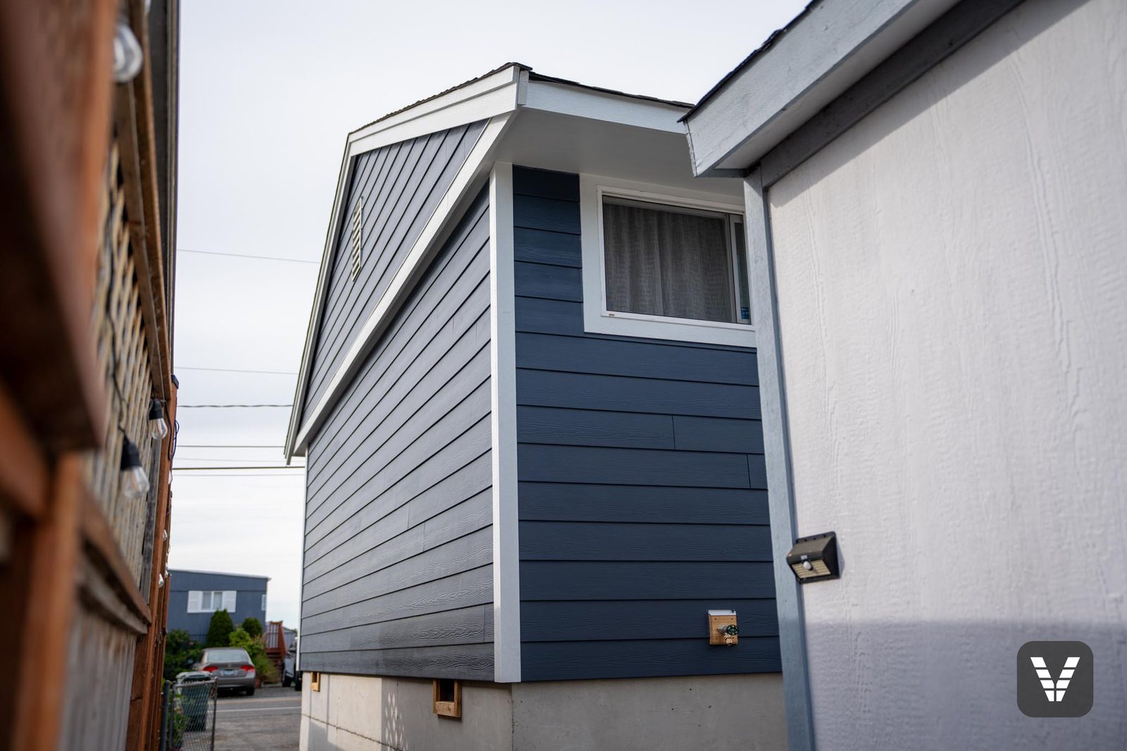 Gable end from the side yard in Deep Ocean with white fascia