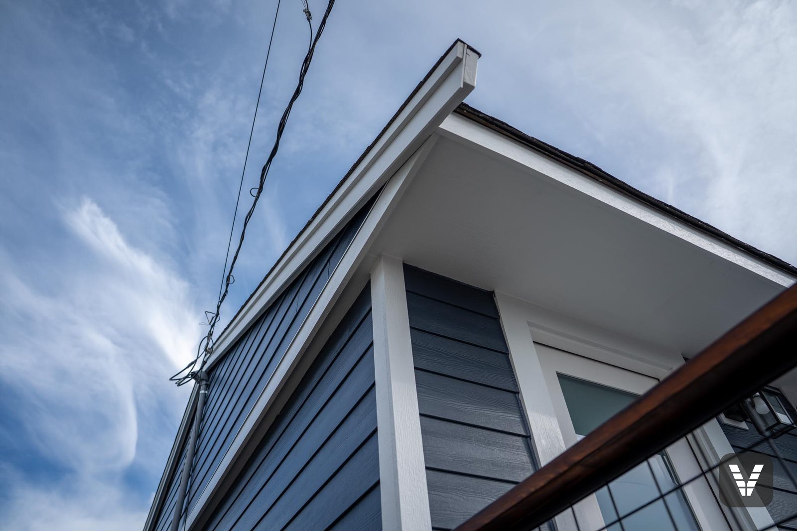 New Arctic White HardieSoffit and fascia meeting the Deep Ocean wall