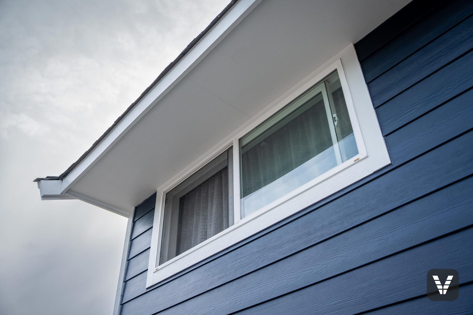 White soffit and window trim set into the navy lap