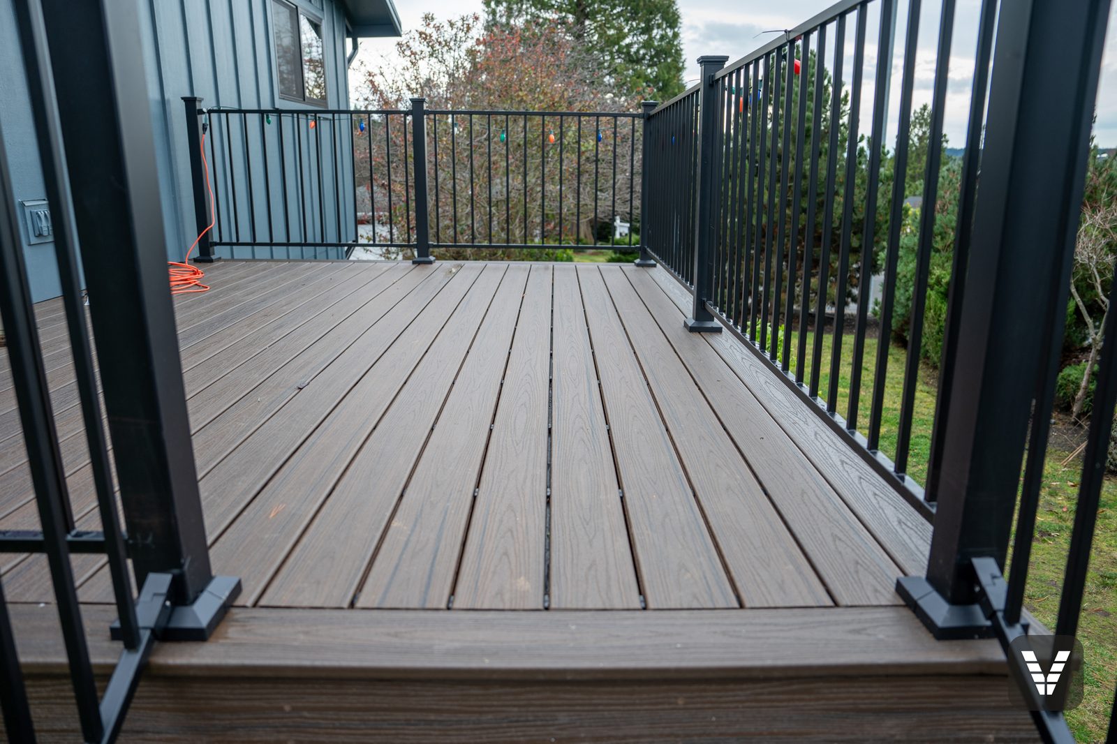 Trex Transcend deck surface with picture-frame border and steel railing — Siding & Window Vault project in Anacortes, WA