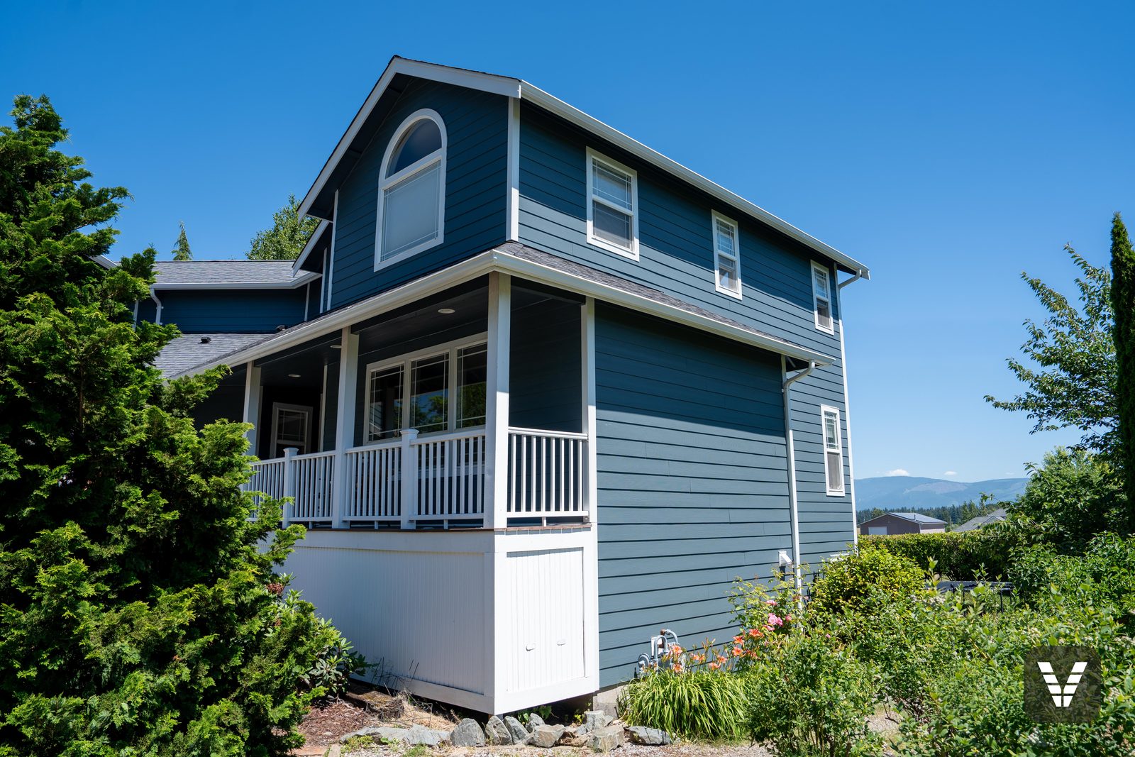 The wrapped porch corner and white skirting