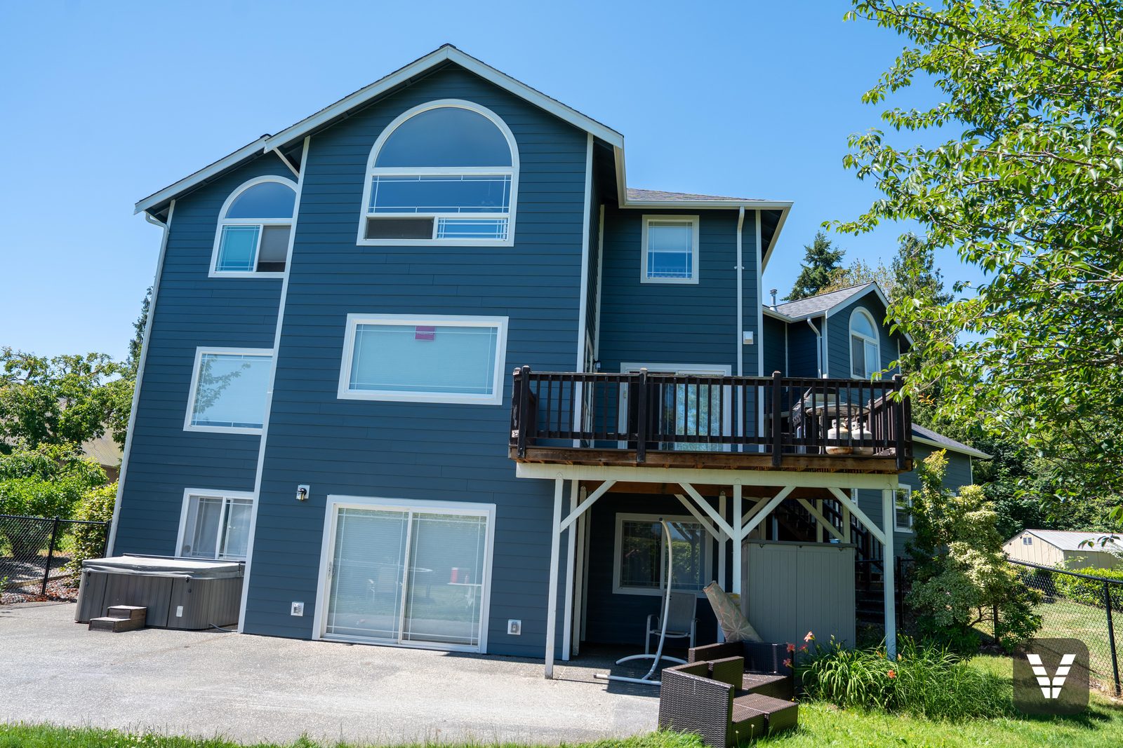 Under the rear deck — posts, skirting, and fresh siding