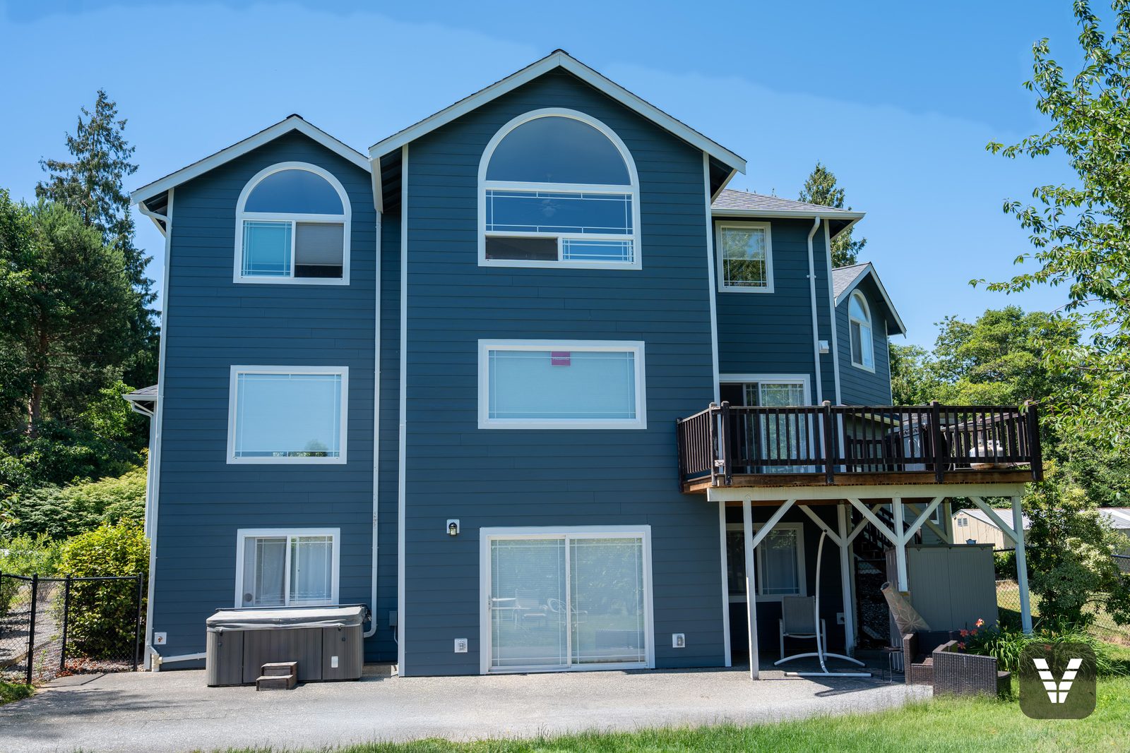 The rear elevation, three stories of new lap and trim