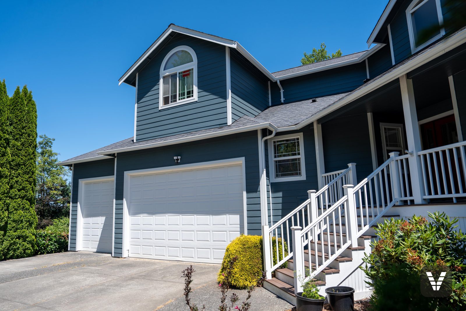 The three-car garage wing and new entry stairs