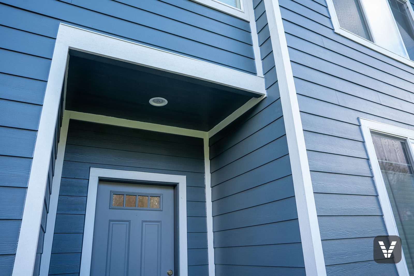 The entry — soffit painted in the siding color at no charge, new trim and clean caulk lines overhead