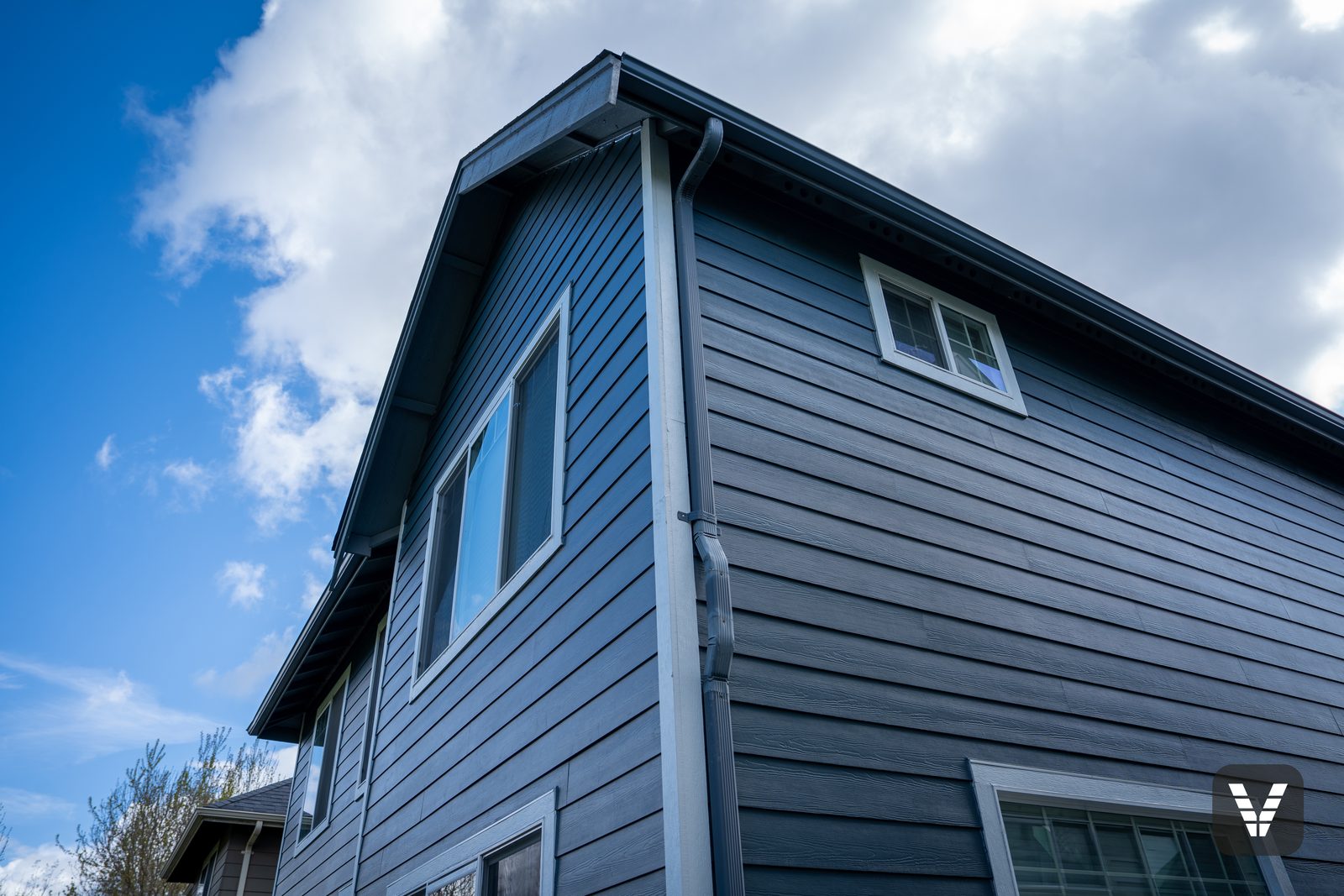 Gable peak and gutter line above the new Cedarmill lap
