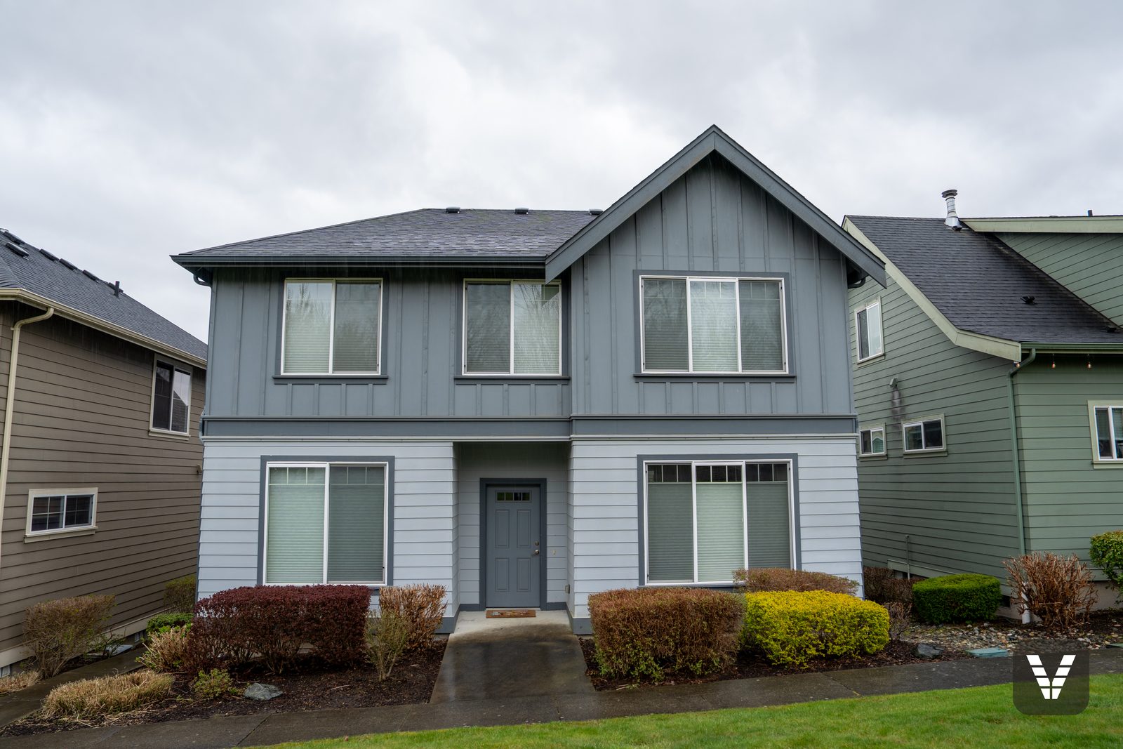 Front elevation before the re-side — original two-tone lap and board-and-batten siding — before, Ferndale, WA