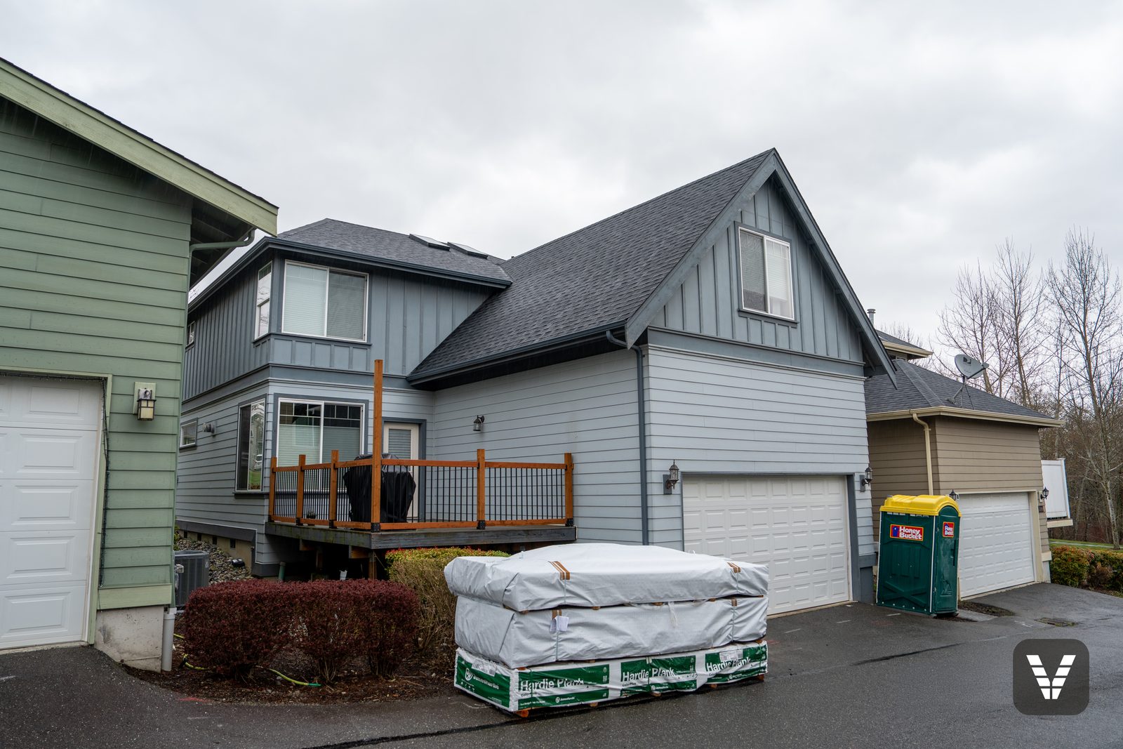 Rear garage before — Evening Blue Hardie delivery staged in the driveway — before, Ferndale, WA