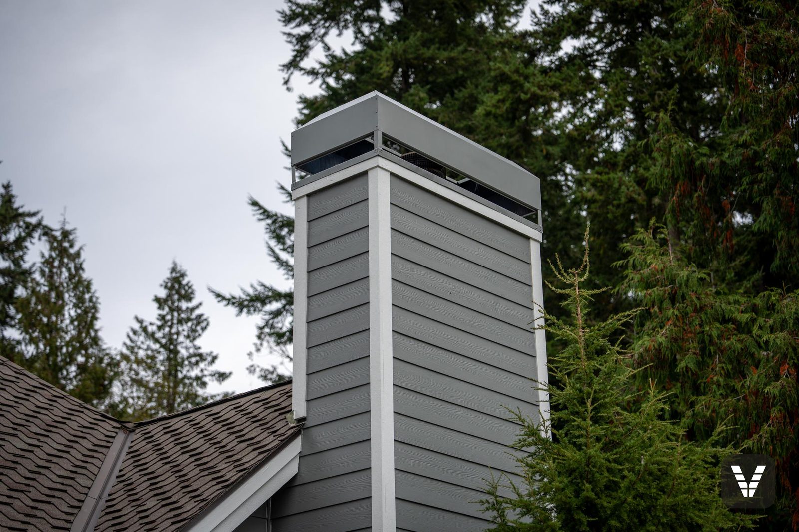 Chimney top detail — new lap siding, Arctic White corners, and cap
