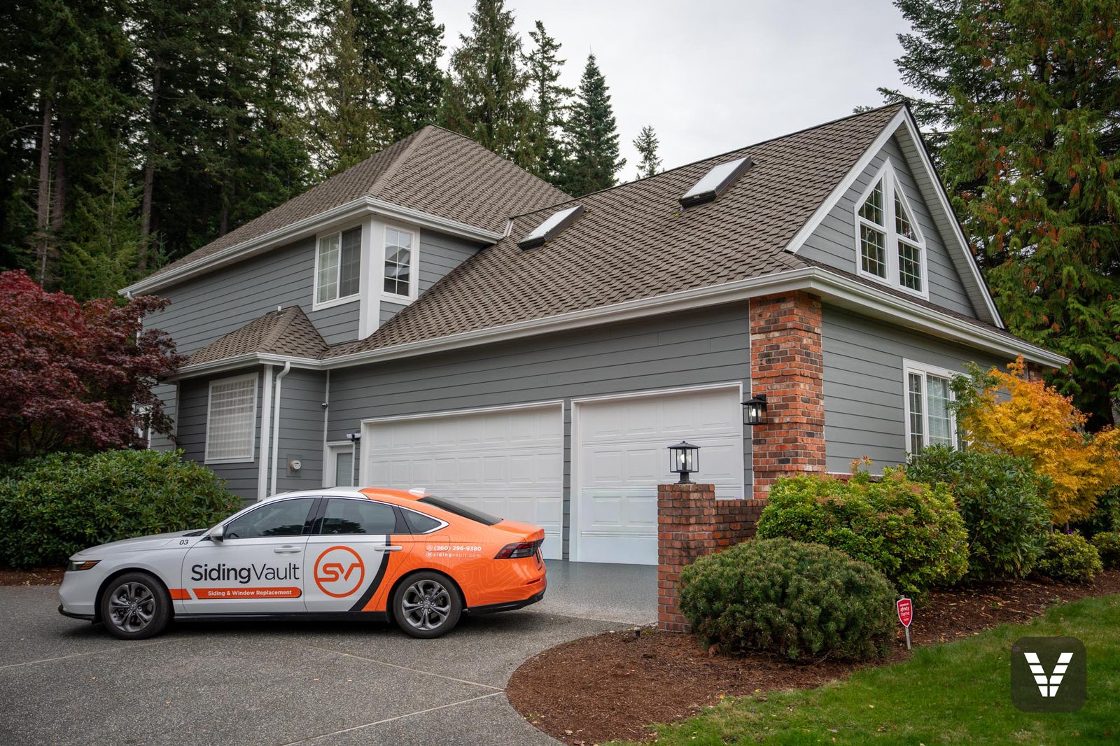 The Siding Vault car out front of a finished Anacortes re-side — our crew, our car, our work