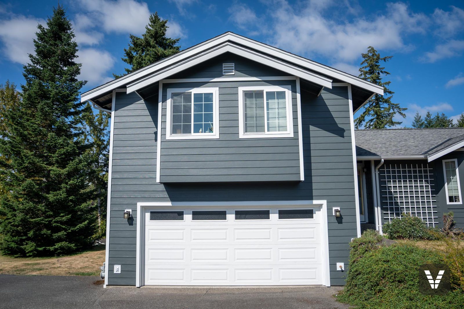 Garage wing straight-on — Iron Gray lap, white trim, new colonial-grid windows