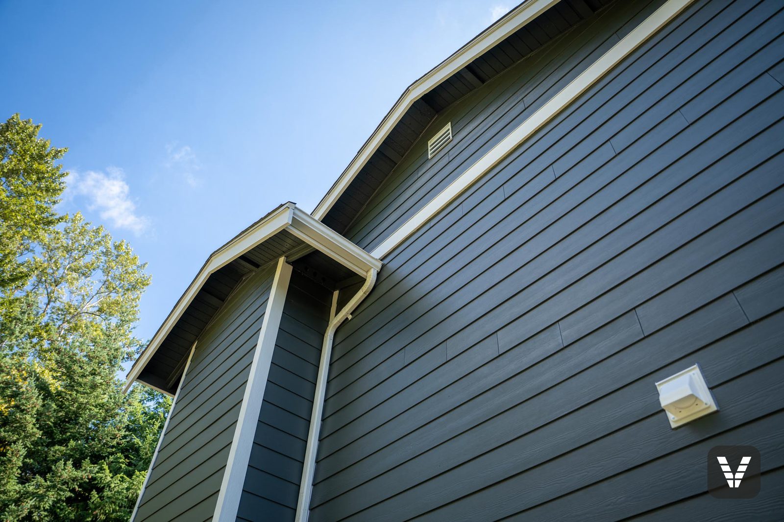 Gable look-up — painted eaves over Iron Gray lap
