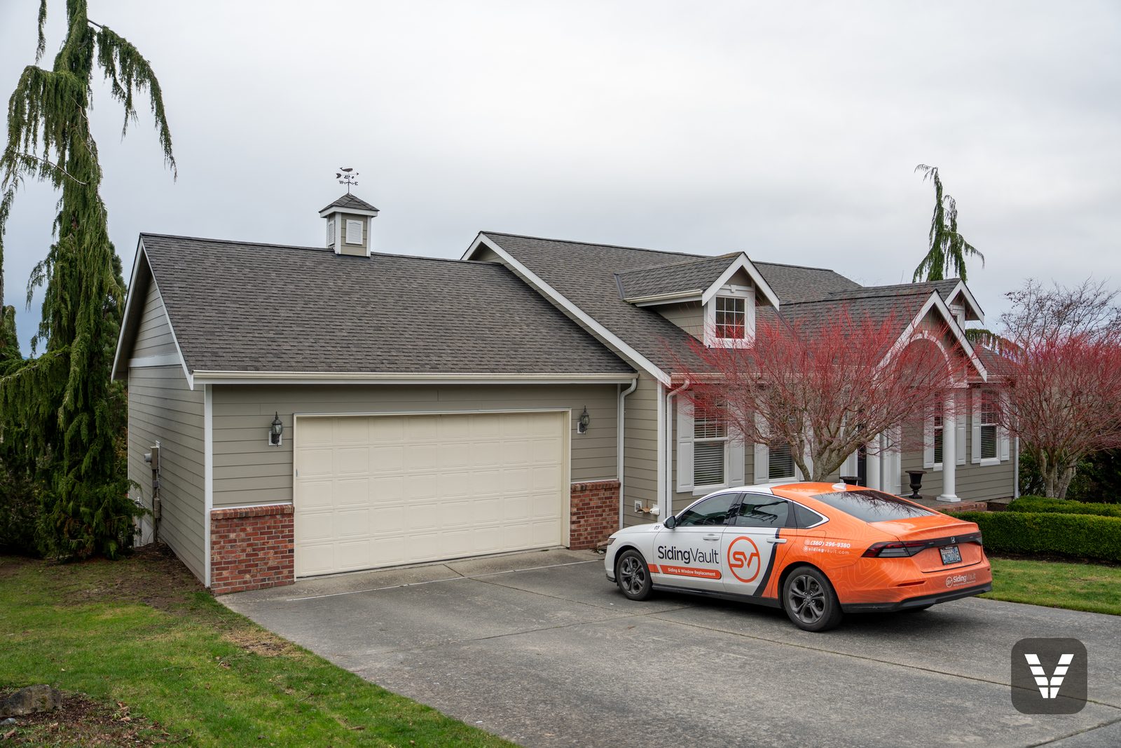 Garage side in Monterey Taupe lap with brick accents and fresh white trim — Siding & Window Vault project in Anacortes, WA
