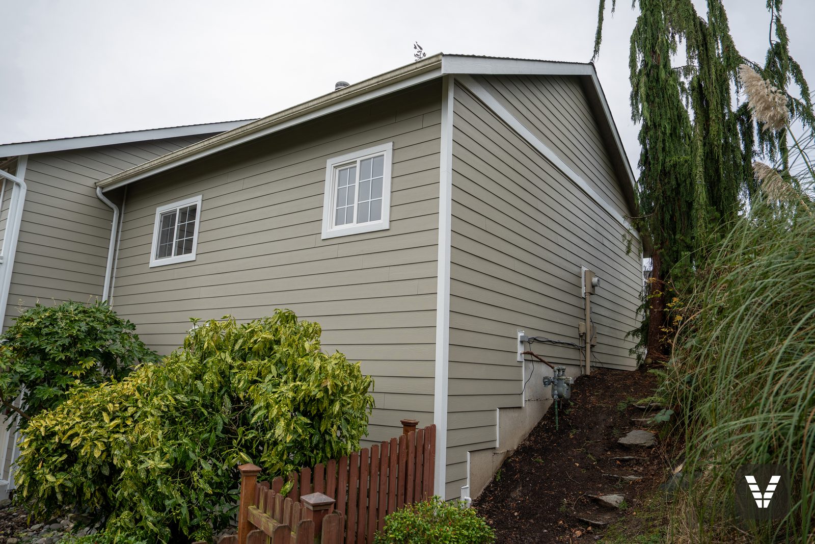 Side gable on the hillside, re-sided and trimmed in white — Siding & Window Vault project in Anacortes, WA