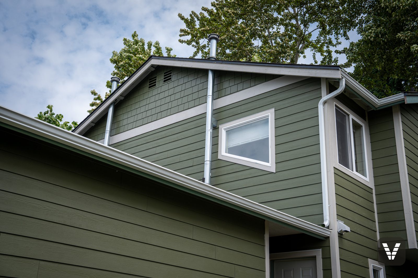 The front gable — straight HardieShingle over a new band board, painted Mountain Sage to match