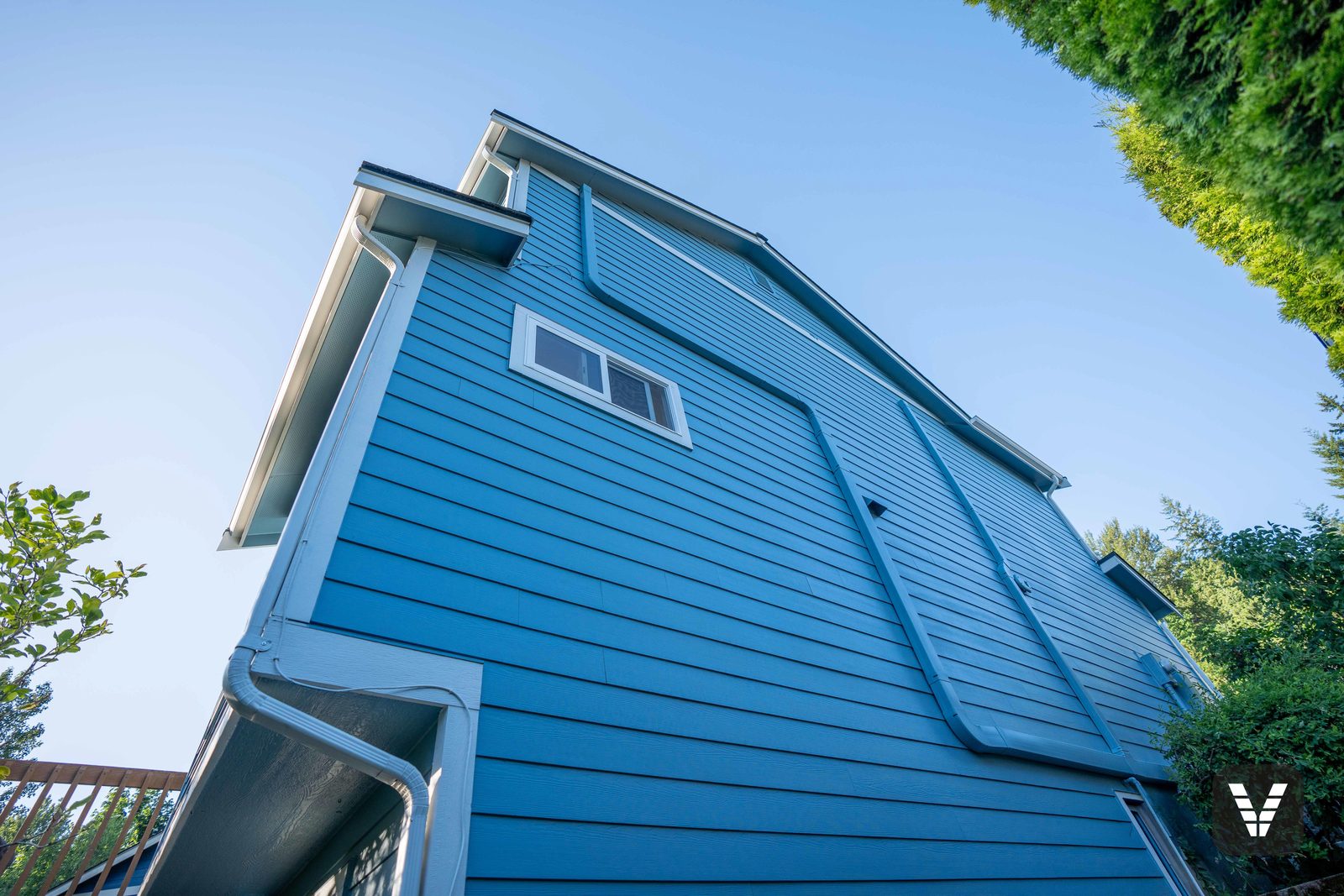 The tall side wall after — clean lap where the paint had been peeling worst — after, SWV project in Bellingham, WA