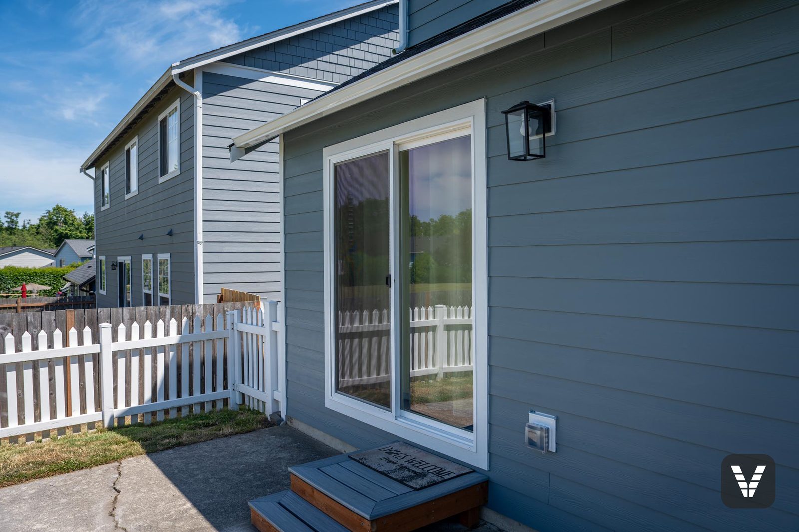 The new Trinsic V300 sliding glass door at the rear patio, flash-taped behind the trim