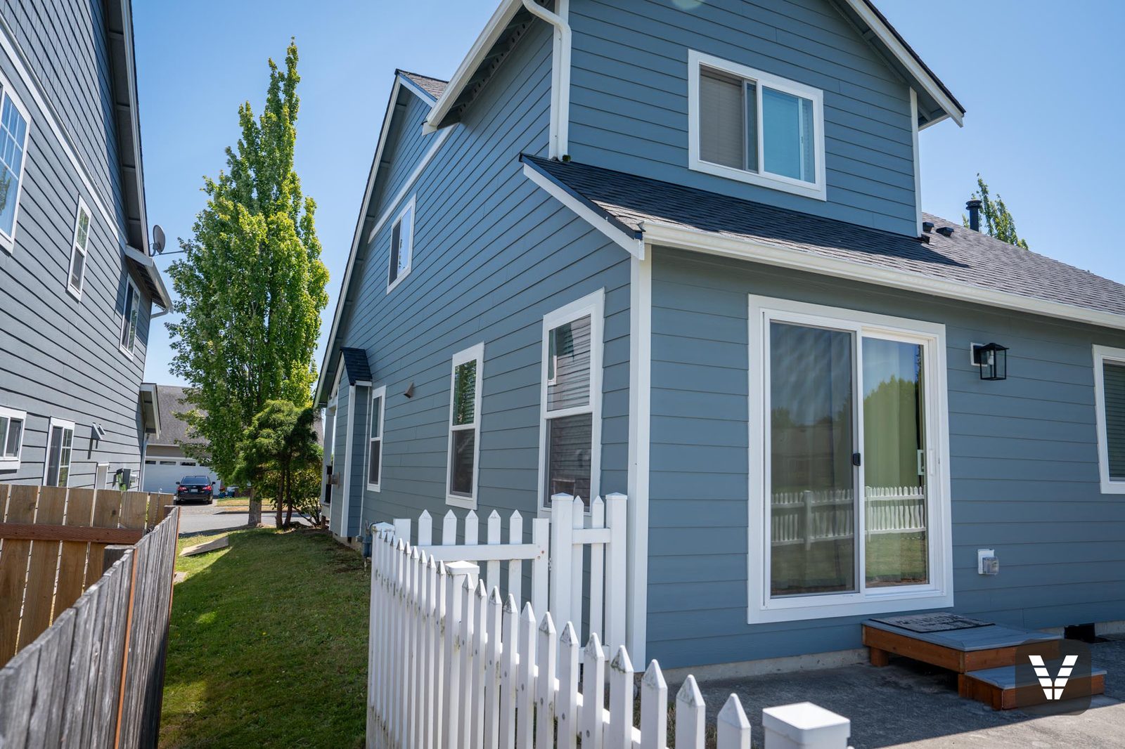 The rear corner past the picket fence — new slider and fresh Boothbay Blue lap