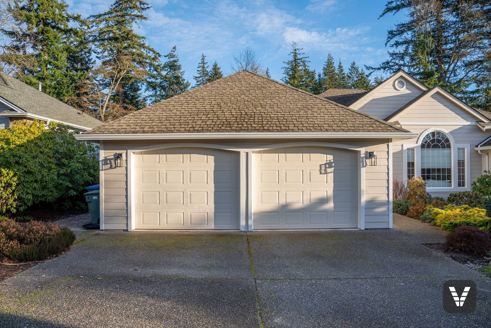 The garage wing in Cobble Stone lap with Arctic White trim and new lantern sconces — Siding & Window Vault project in Bellingham, WA