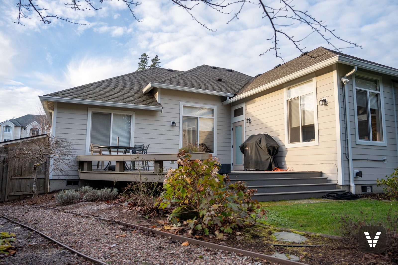 The rear of the home in fresh Cobble Stone lap above the existing deck