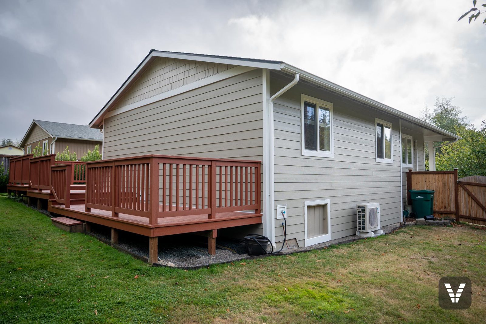 Rear-right corner — new lap, trim, and gutters above the deck