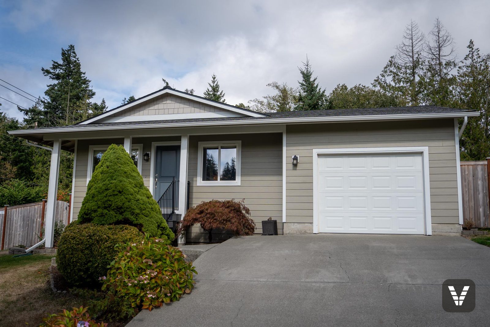 The finished front — taupe lap, shingled porch gable, new window — Siding & Window Vault project in Anacortes, WA