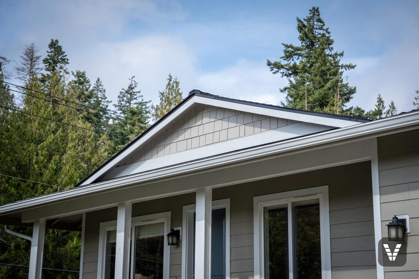 The porch gable — Cobblestone shingle above an upper beam wrapped in HardieTrim, the upgrade Michael suggested for the entry — Siding & Window Vault project in Anacortes, WA