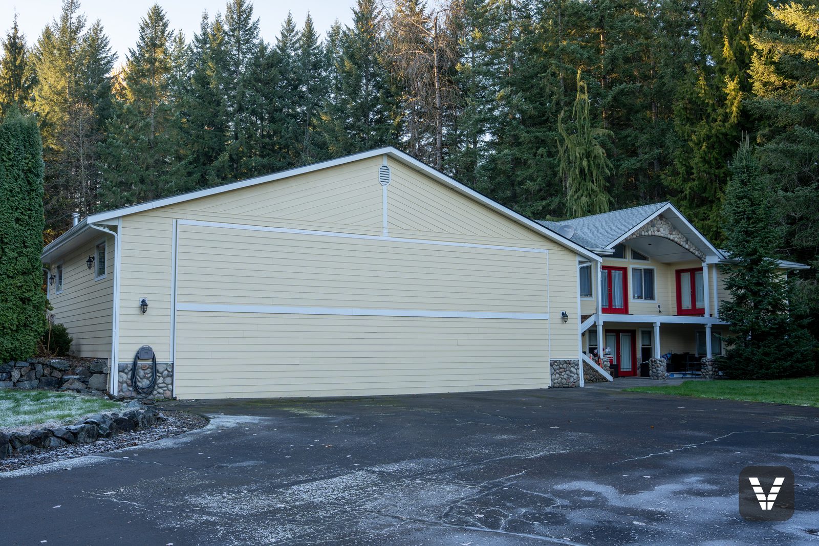 The hangar wall from the drive, new siding and trim lines — Siding & Window Vault project in Lake Stevens, WA